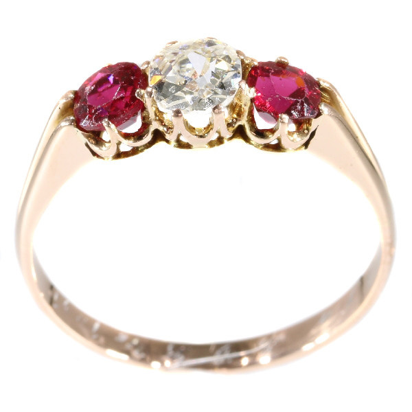 Antique ring with old mine brilliant cut diamond and two red strass stones by Artista Desconocido
