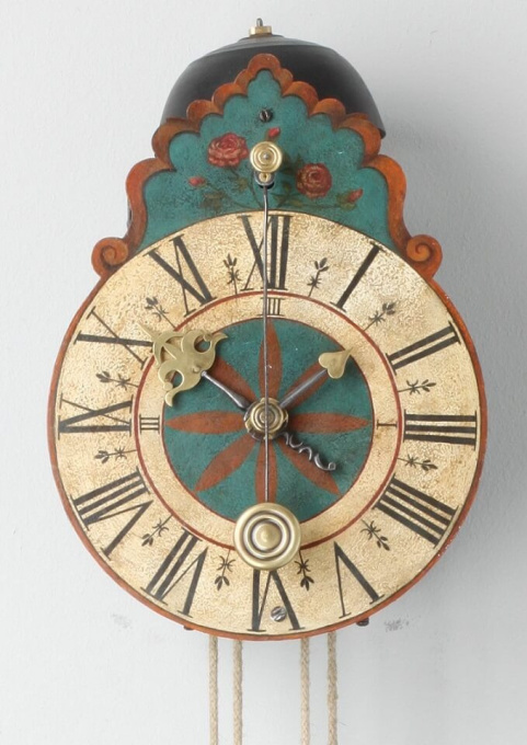 A South German polychrome wall clock, circa 1710 by Onbekende Kunstenaar