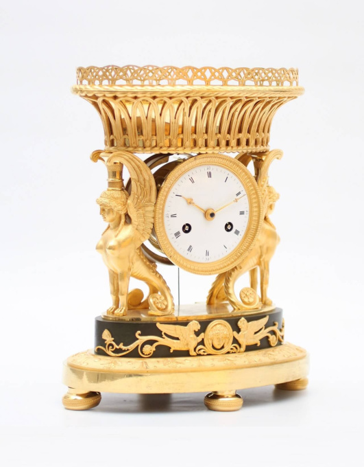 A French Empire ormolu urn mantel clock with griffins, circa 1800 by Unknown artist