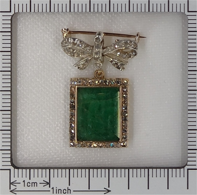 Antique Victorian diamond bow brooch with large emerald pendant hanging underneath by Artiste Inconnu