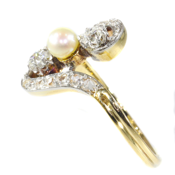 Antique diamond and pearl cross-over engagement ring by Artista Sconosciuto