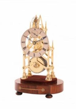 A small English brass skeleton clock with balance wheel, circa 1840 by Unknown Artist