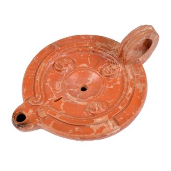  A Roman terracotta red slip ware oil lamp with theatre masks by Unknown Artist
