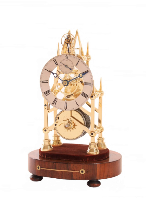 A small English brass skeleton clock with balance wheel, circa 1840 by Artista Sconosciuto